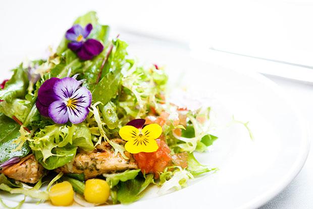 A salad prepared with edible flowers